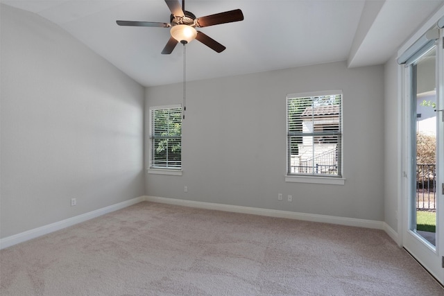 carpeted empty room with plenty of natural light, ceiling fan, and lofted ceiling