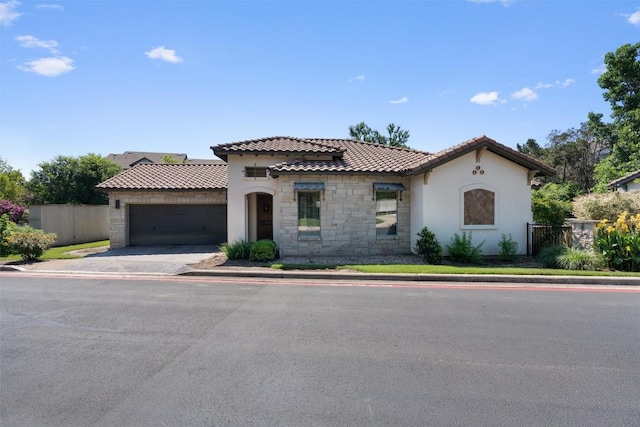 mediterranean / spanish home featuring a garage