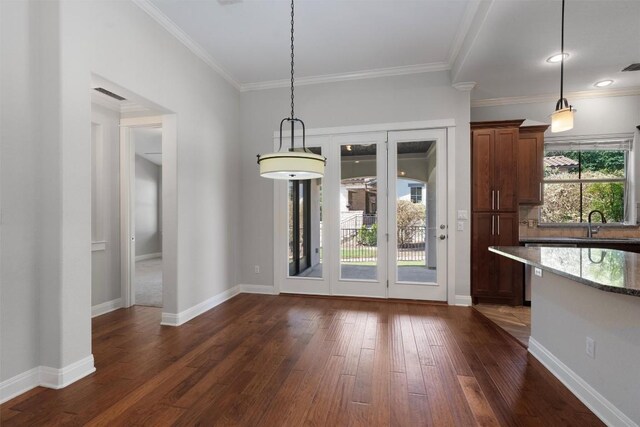 13909 Yellow Bell Bnd, Austin, TX 78738 - unfurnished dining area with a sink, dark wood finished floors, baseboards, visible vents, and ornamental molding