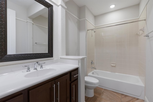 full bathroom with tile patterned floors, vanity, toilet, and tiled shower / bath