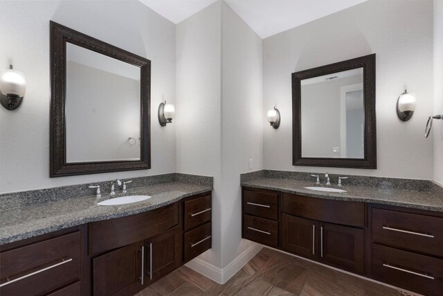 13909 Yellow Bell Bnd, Austin, TX 78738 - bathroom with baseboards, a sink, and two vanities