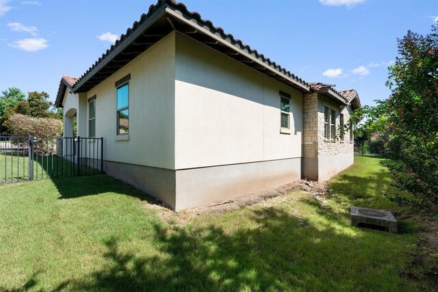 13909 Yellow Bell Bnd, Austin, TX 78738 - view of side of property with a tile roof, stucco siding, fence, and a lawn