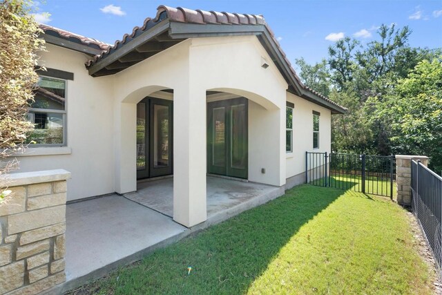 13909 Yellow Bell Bnd, Austin, TX 78738 - back of house with a tile roof, stucco siding, fence, a patio, and a lawn