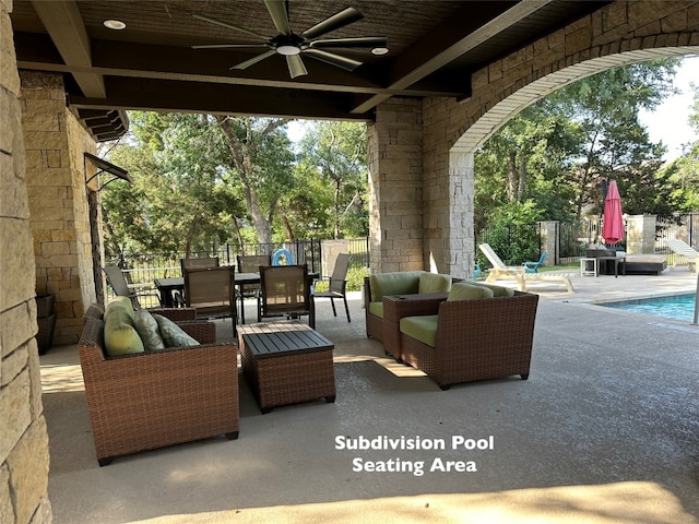 view of patio / terrace featuring ceiling fan and a fenced in pool