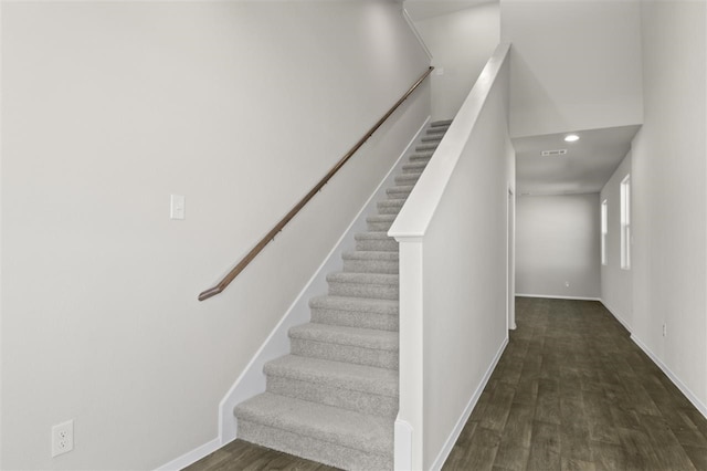 stairway with hardwood / wood-style floors