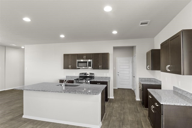 kitchen featuring dark hardwood / wood-style flooring, sink, a center island with sink, and stainless steel appliances