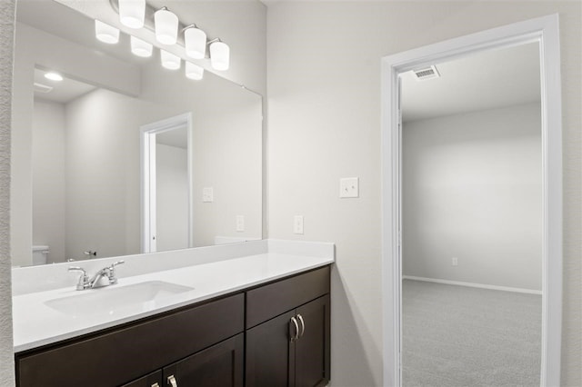 bathroom with toilet and vanity