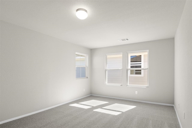 unfurnished room with carpet flooring