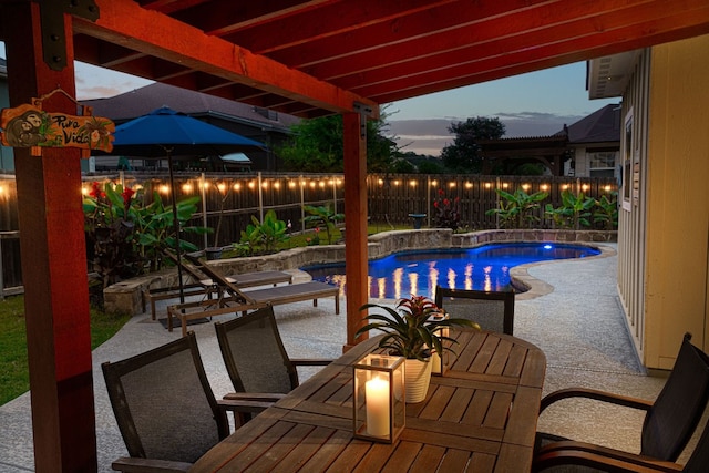 pool at dusk featuring a patio