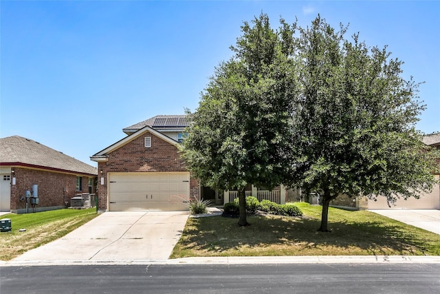 view of property hidden behind natural elements featuring a front lawn and central air condition unit