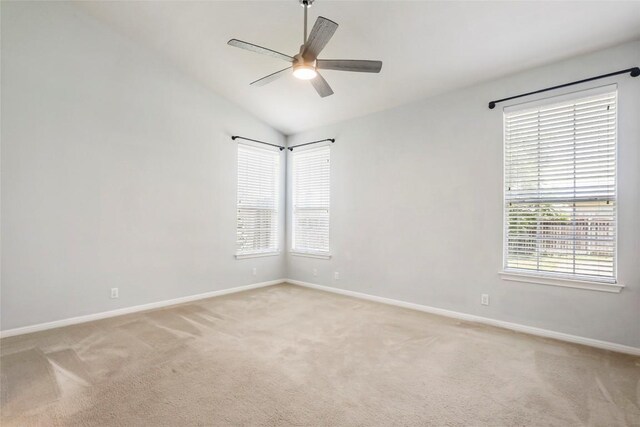 carpeted empty room with lofted ceiling and ceiling fan