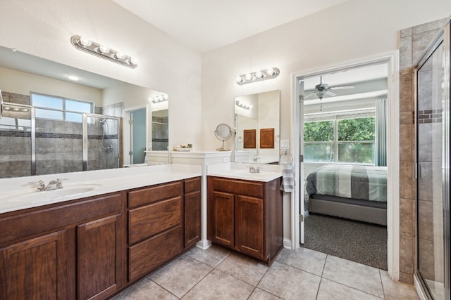 bathroom with tile patterned flooring, vanity, ceiling fan, and walk in shower