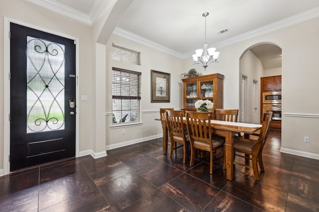 dining space featuring a notable chandelier and ornamental molding