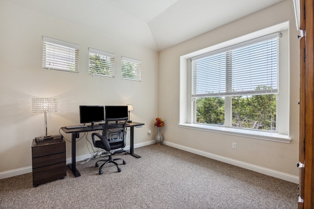 carpeted office featuring vaulted ceiling and a healthy amount of sunlight