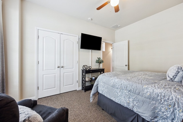 bedroom with a closet, ceiling fan, and carpet flooring