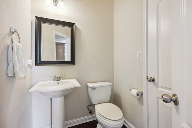 bathroom featuring sink and toilet