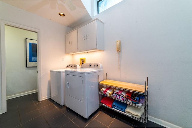 laundry area with cabinets, dark tile patterned floors, and washer and dryer