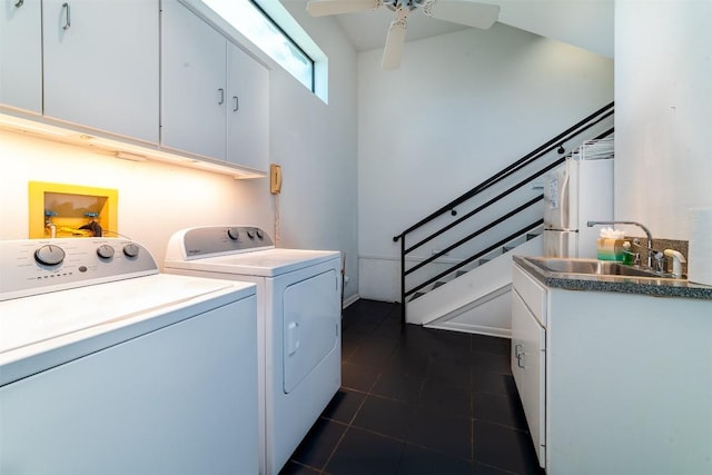 laundry area featuring ceiling fan, sink, cabinets, dark tile patterned floors, and washer and dryer