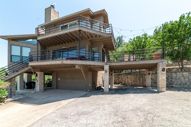 view of front of property featuring a garage and a carport