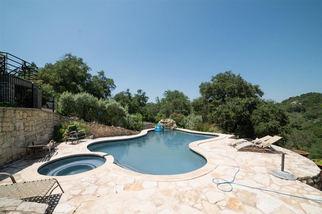 view of pool featuring an in ground hot tub and a patio