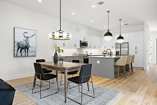 dining room with light wood-type flooring