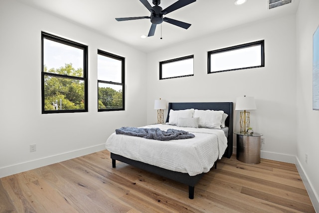 bedroom with ceiling fan and hardwood / wood-style floors