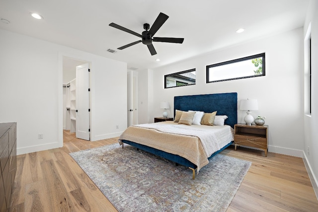 bedroom with ceiling fan and light wood-type flooring