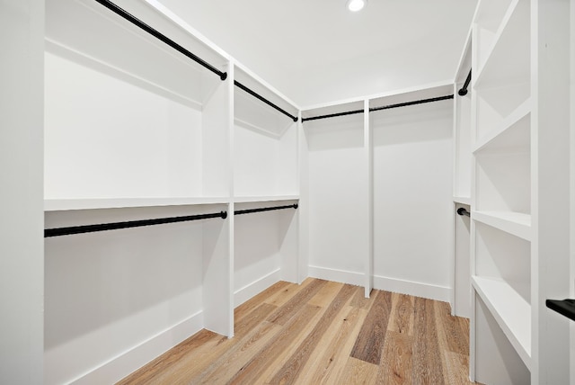 walk in closet featuring light hardwood / wood-style flooring