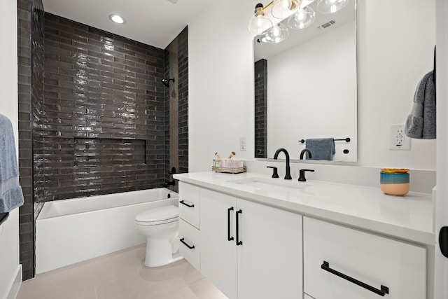 full bathroom featuring tile patterned floors, toilet, vanity, and tiled shower / bath