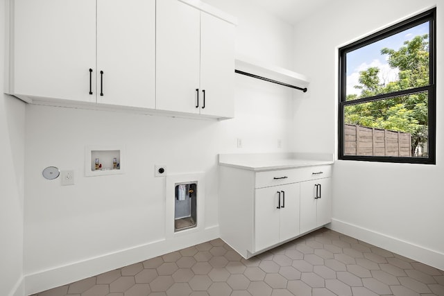 laundry room with cabinets, hookup for a washing machine, and electric dryer hookup