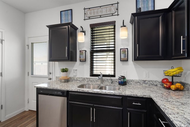 kitchen featuring sink, light stone counters, stainless steel dishwasher, dark hardwood / wood-style floors, and pendant lighting