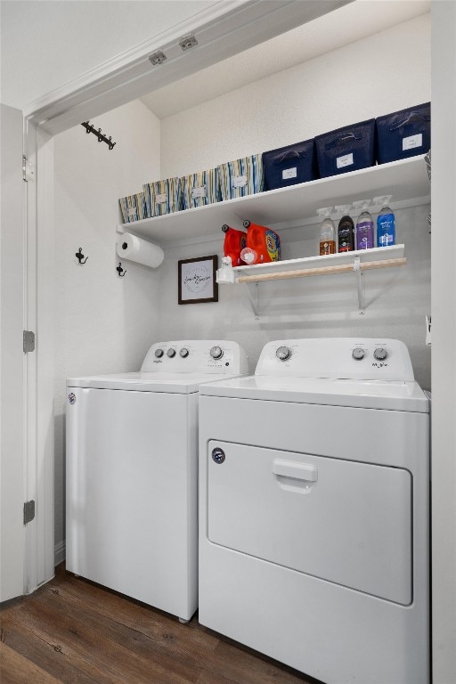 laundry area with washing machine and dryer and dark wood-type flooring