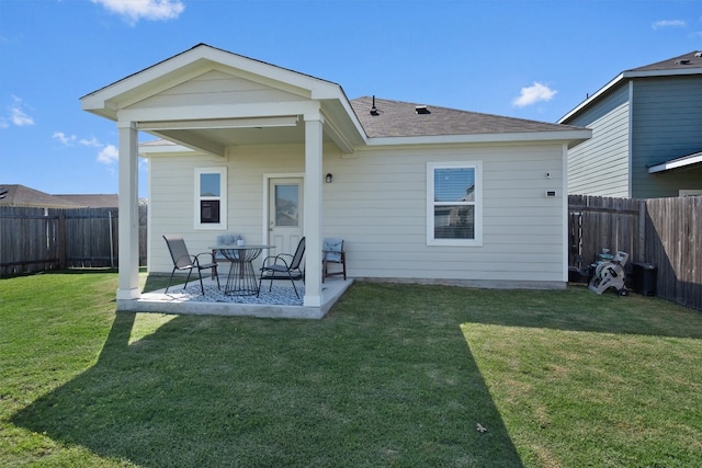 back of property featuring a patio area and a yard