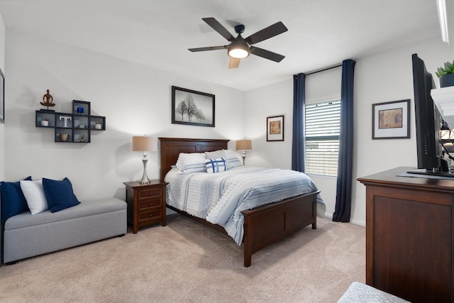 bedroom with ceiling fan and light carpet