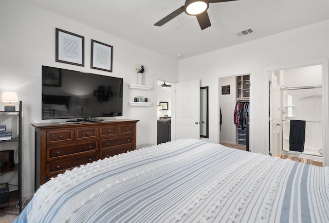 bedroom with ensuite bathroom, ceiling fan, a spacious closet, and a closet