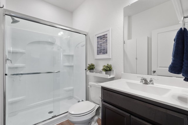 bathroom with vanity, toilet, and walk in shower