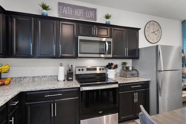 kitchen featuring light stone countertops and appliances with stainless steel finishes