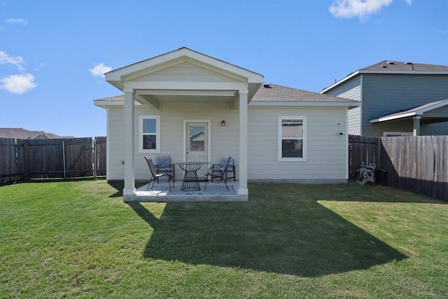 rear view of property with a patio area and a lawn