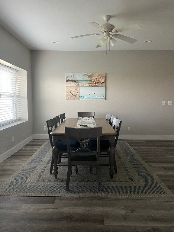 dining space featuring ceiling fan and dark hardwood / wood-style flooring