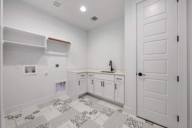 washroom featuring light tile patterned flooring, sink, electric dryer hookup, gas dryer hookup, and cabinets