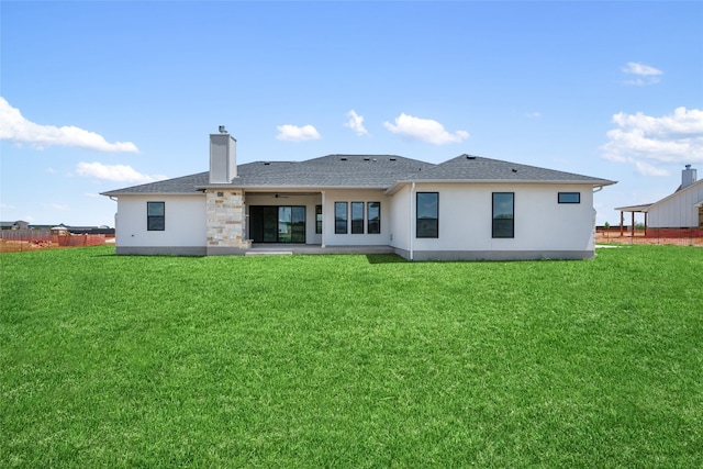 back of house featuring a patio and a lawn