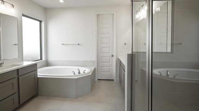 bathroom with tile patterned floors, a wealth of natural light, vanity, and separate shower and tub