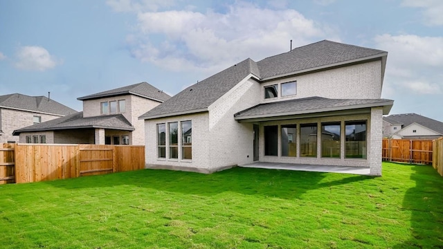 back of property with a patio area and a lawn