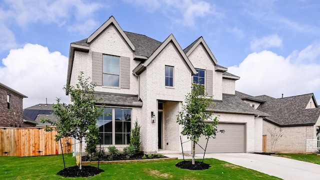 view of front of house with a garage and a front yard