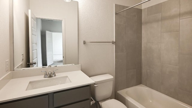 full bathroom with vanity, toilet, and tiled shower / bath