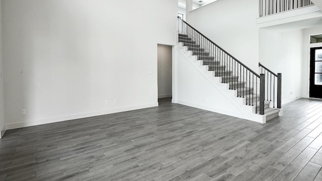 unfurnished living room with a high ceiling