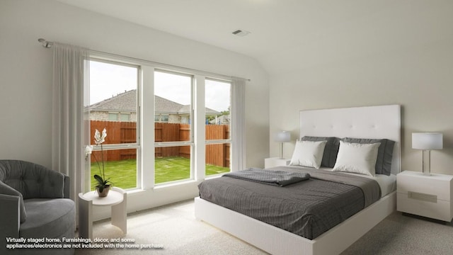 carpeted bedroom with vaulted ceiling