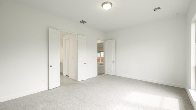 unfurnished bedroom featuring light colored carpet