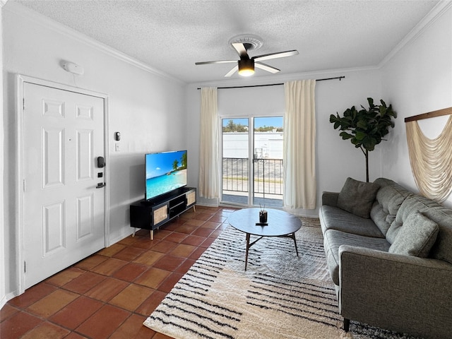 living room with dark tile patterned flooring, ceiling fan, crown molding, and a textured ceiling