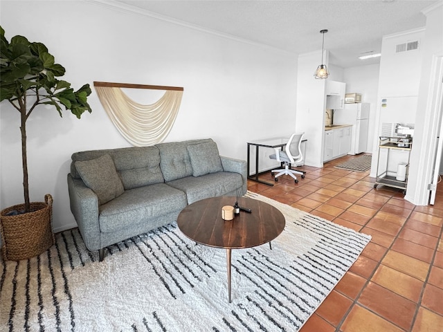 living room with tile patterned flooring, a textured ceiling, and ornamental molding